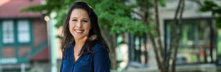 Criminal Justice M.S. student Manijéh Pickard on campus wearing a navy blouse