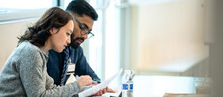 Graduate business students collaborate on a project together