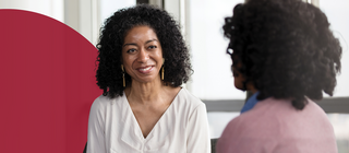 Encouraging female mental health professional actively listens to a patient.