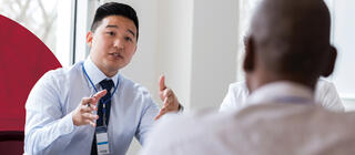 A healthcare administrator in a meeting with other professionals