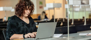 A Saint Joseph's University student types on a laptop