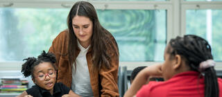 Saint Joseph's education student working with a young elementary student in a classroom