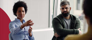 Female social worker calls on member of group during session