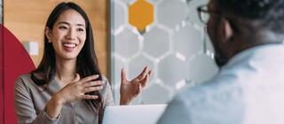 A business woman talks to her colleagues in the office