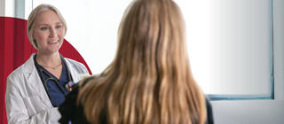 Saint Joseph's female Physician Assistant student chats with female patient