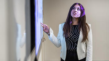 An MBA student presents a data analysis to their class